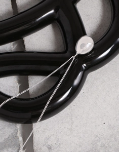 Close-up of minimalist S925 silver long necklace with polished water drop pendant