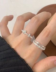 Detailed view of S925 silver irregular rings set with double knot and wavy stone patterns