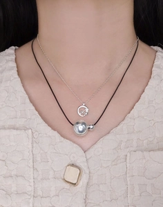 Layered S925 silver necklace featuring a polished sphere pendant and black cord design