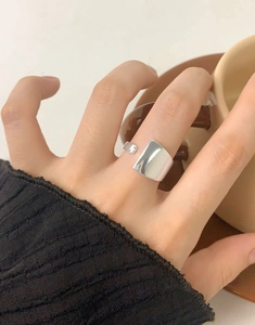 Close-up of minimalist S925 sterling silver irregular geometric ring on woman's hand