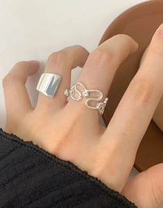 Close-up of minimalist geometric S925 silver rings with zircon on a model's fingers