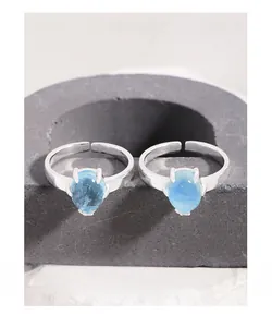 Macro shot of S925 sterling silver stamp and oval blue gemstone on adjustable ring