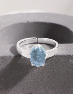 Macro shot of S925 sterling silver ring featuring oval natural aquamarine and claw setting