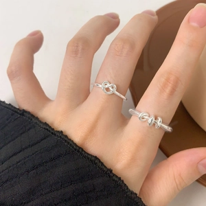 Elegant S925 sterling silver irregular triple loop and heart knot rings on model hand