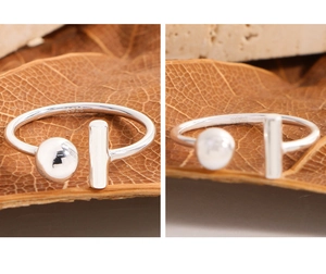 Close-up of S925 sterling silver ring showing the asymmetric bead and T-bar design details