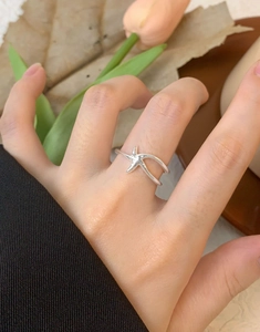 Close-up of minimalist S925 sterling silver starfish open ring worn on a hand
