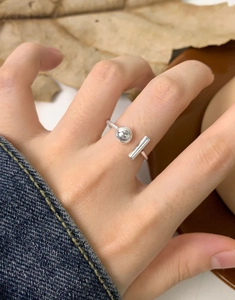 Detailed shot of an asymmetric S925 silver ring with ball and bar on hand
