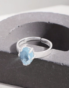 Macro shot of S925 sterling silver stamp and oval aquamarine stone on adjustable ring