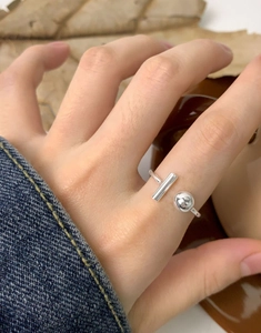 Detail of S925 sterling silver asymmetric open ring with ball and T-bar design