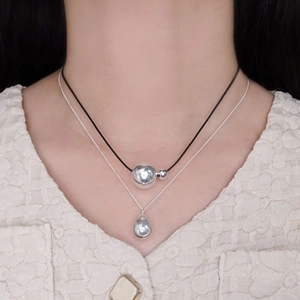 S925 sterling silver teardrop pendant and layered black cord necklace on a model