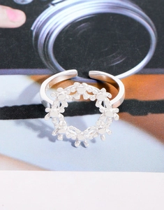 Macro shot showing the S925 hallmark on the inner band of the floral silver ring