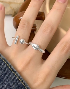 Close-up of S925 sterling silver rings with geometric beads and pebble relief designs