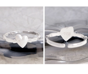 Macro detail of S925 sterling silver stamp on the matte heart ring with adjustable band