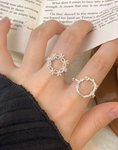 Close-up of S925 sterling silver adjustable rings with flower and vine leaf designs