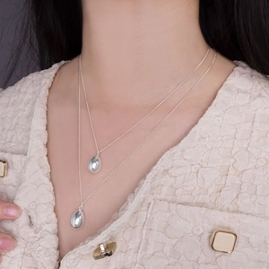 Double-layered S925 sterling silver necklace featuring minimalist water drop pendants