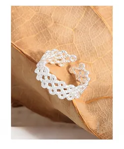 Close-up of S925 sterling silver ring featuring a hollow woven lace design on a leaf