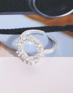 Macro shot of S925 sterling silver floral ring showing interior hallmark and fine texture