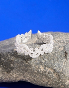Macro view of S925 sterling silver braided ring showing fine textures and metal hallmark