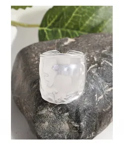 Close-up of S925 sterling silver wide ring with irregular liquid metal texture on black rock