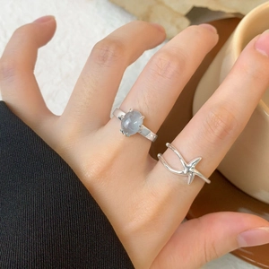 Minimalist S925 sterling silver starfish open ring with oval blue gemstone worn on finger