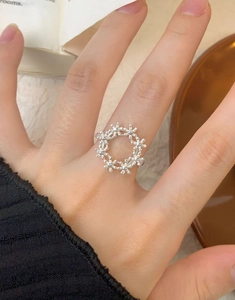 Close-up of S925 sterling silver hollow flower ring with delicate micro-bead texture