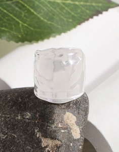 Macro detail of the resin ring with unique ice texture and irregular embossed surface