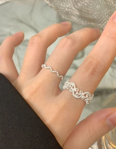 Detail of S925 sterling silver rings featuring twisted woven texture and wavy design