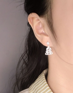 Close-up of S925 silver Christmas tree earrings with star stud and zircon inlay on ear