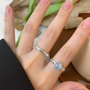 Hand wearing S925 silver rings with natural aquamarine stone in a minimalist aesthetic style