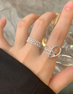 Detailed view of S925 sterling silver braided lace and geometric lava texture rings