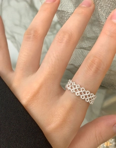 Close-up of S925 sterling silver woven lace ring featuring intricate beaded hollow design