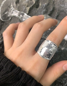 Macro detail of wide S925 sterling silver ring with textured foil finish on model