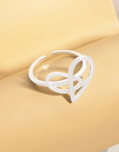 Detail of silver S925 heart infinity open ring with polished adjustable band