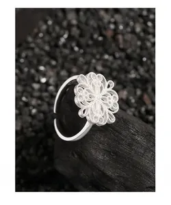 Macro shot of S925 sterling silver ring featuring a detailed hollow floral design