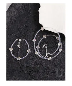 Macro view of Aurora crystal beaded necklace and bracelet with silver heart pendant