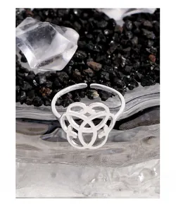 Detailed view of silver geometric intertwined circles on an adjustable open ring band
