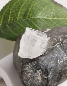 Close-up of S925 sterling silver wide ring with organic lava texture on natural stone