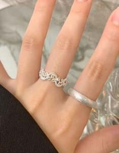 Detail of S925 silver rings showing intricate woven texture and matte finish surface