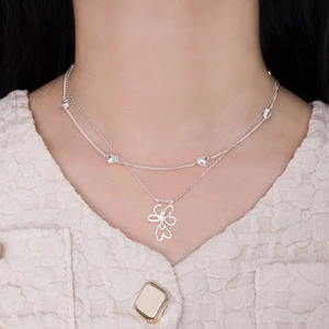 Double-layer S925 silver necklace with heart beads and hollow flower pendant on model