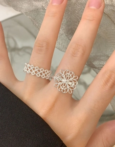 Detailed view of S925 silver rings featuring hollow lace and floral filigree textures