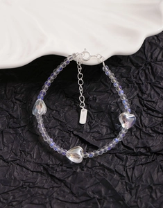 Detailed view of S925 silver stamp on heart crystal beaded bracelet with aurora glow