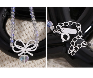Macro detail of S925 sterling silver heart crystal necklace with bowknot pendant