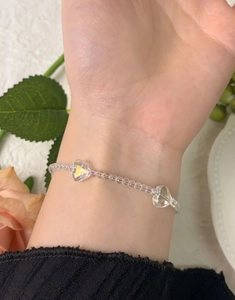 Detail of S925 sterling silver beaded bracelet with heart crystal charms on wrist