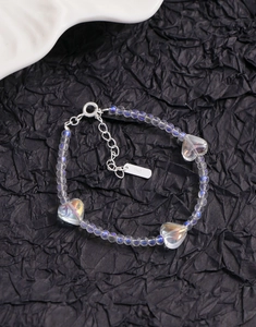 Close-up of S925 silver clasp and heart beads on iridescent beaded bracelet