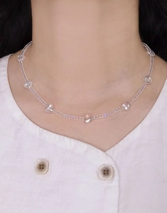 Close-up of iridescent heart-shaped crystal beads on an elegant S925 silver necklace