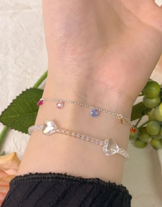 Close-up of S925 silver beaded bracelet set with crystal hearts and colorful gemstones
