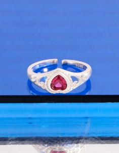 Detailed close-up of S925 sterling silver ring with heart-shaped red zircon stone