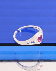 Macro view of S925 silver heart ring featuring red corundum and vintage filigree details