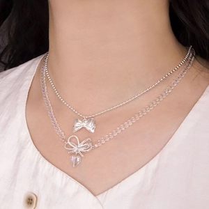 Double layer S925 silver necklace with heart crystal and bow pendants on a model