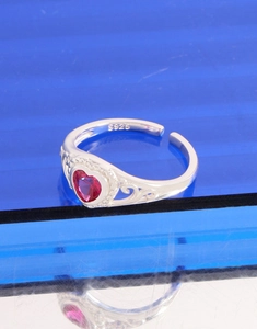 Macro detail of S925 sterling silver stamp and intricate filigree on heart ring band